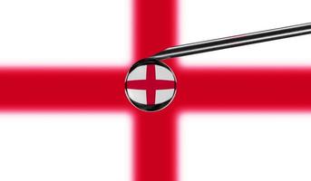 Vaccine syringe with drop on needle against national flag of England background. Medical concept vaccination. Coronavirus Sars-Cov-2 pandemic protection. National safety idea. photo