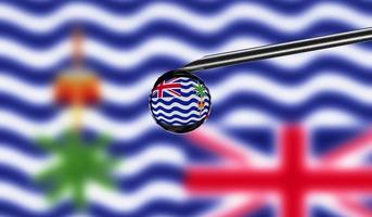 Vaccine syringe with drop on needle against national flag of British Indian Ocean Territory background. Medical concept vaccination. Coronavirus Sars-Cov-2 pandemic protection. National safety idea. photo