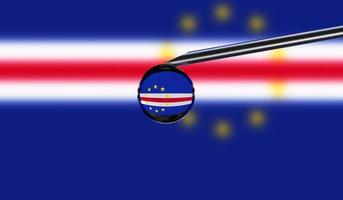 Vaccine syringe with drop on needle against national flag of Cape Verde background. Medical concept vaccination. Coronavirus Sars-Cov-2 pandemic protection. National safety idea. photo