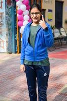 New Delhi, India - December 04 2022 - Unidentified people showing their ink-marked fingers after casting votes in front of polling booth of east Delhi area for MCD local body Elections 2022 photo