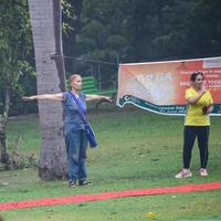 New Delhi, India, June 18 2022 - Group Yoga exercise class Surya Namaskar for people of different age in Lodhi Garden, International Yoga Day, Big group of adults attending a yoga class in park photo