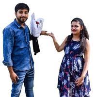 Indian couple posing for maternity baby shoot with white plain background. The couple is posing in a lawn with green grass and the woman is falunting her baby bump in Lodhi Garden in New Delhi, India photo