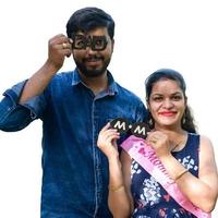 Indian couple posing for maternity baby shoot with white plain background. The couple is posing in a lawn with green grass and the woman is falunting her baby bump in Lodhi Garden in New Delhi, India photo