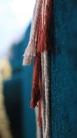 Close up of red and white rope on blue background. Selective focus. photo