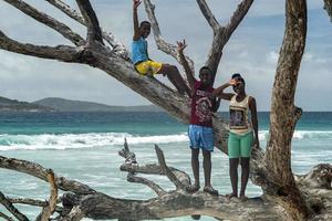 LA DIGUE, SEYCHELLES - AUGUST 25 2019 - Young islands boys pose for photographer photo