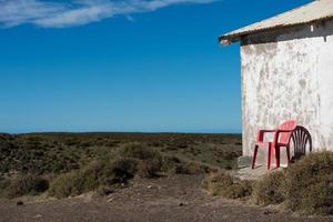 Chair outside patagonia lighthouse in valdes peninsula photo