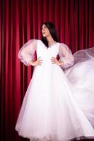 Asian woman posing in a white wedding dress and had black hair photo