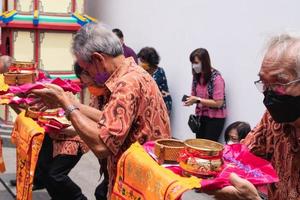 Bandung City, Indonesia, 2022 - the congregation praying together at the Buddhist altar with the monks photo