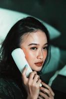 Beautiful women receive phone calls from a loved one in the night photo