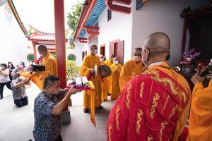 Bandung City, Indonesia, 2022 - Buddhist community praying together with the monks in front of the altar photo