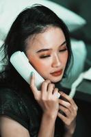 Beautiful women receive phone calls from a loved one in the night photo