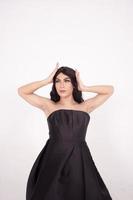Portrait shoot of Asian woman with black dress poses in black hair photo