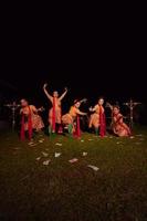 Javanese dancers with beautiful makeup and traditional costume while dancing the traditional dance on the stage photo