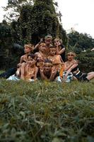 Balinese people have fun together with their friends in golden costumes after the dance performance photo