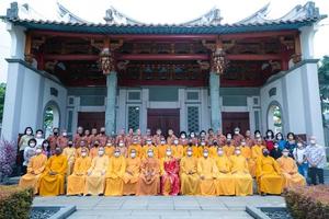 Bandung City, Indonesia, 2022 - The monks sitting together for taking a photo in front of the Chinese gate