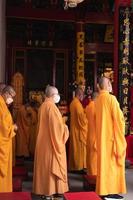 Bandung City, Indonesia, 2022 - The chief monk led the praying process on the Buddhist altar with the offerings photo