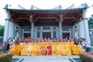 Bandung City, Indonesia, 2022 - The monks sitting together for taking a photo in front of the Chinese gate