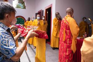 Bandung City, Indonesia, 2022 - Buddhist community praying together with the monks in front of the altar photo