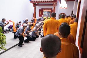 Bandung City, Indonesia, 2022 - Buddhist community praying together with the monks in front of the altar photo