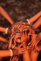 Sad Man Faces covered up by a lot of hands with henna tattoos while wearing a gold crown photo