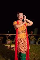 Beautiful Javanese woman with a golden necklace on her neck and golden belt on a yellow dress on their body photo