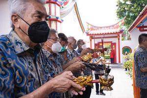 Bandung City, Indonesia, 2022 - Buddhist community praying together with the monks in front of the altar photo