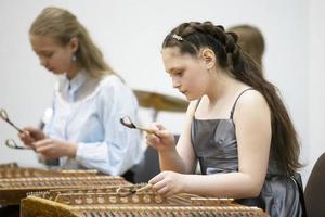 May 21, 2021 Belarus. city of Gomil. Holiday at the music school.The girl plays the ethnic instrument dulcimer photo