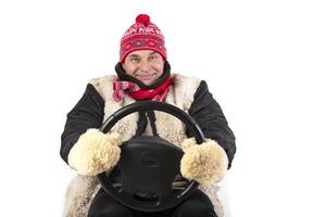 Funny adult man holding a car steering wheel on a white background. photo