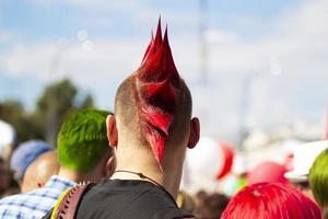 Belarus, Gomil, August 16, 2020. Crowded city streets. A young man with a punk hairstyle stands with his back to the camera. photo