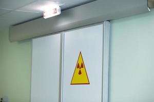 Radiation sign on the doors in the hospital. High radiation warning. photo