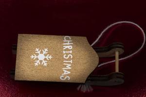 Vintage toy sled made of wood on a dark red background. photo