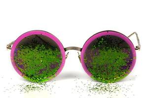 Glamorous sunglasses with green sparkles on a white background. photo