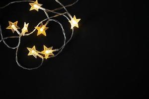 Christmas background with lights and space for free text. Christmas lights from a garland on a black background. photo