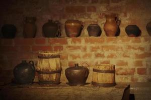 Vintage crockery, wooden barrels in an old cellar. photo