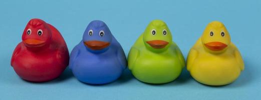 Multi-colored rubber ducks on a blue background. photo