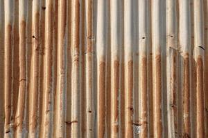 Artistic of old and rusty zinc sheet wall. Vintage style metal sheet roof texture. Pattern of old metal sheet. Rusting metal or siding. Corrosion of galvanized. Background and texture in retro concept photo