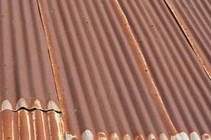 The tin roof background with the rust and nails hole by vintage style. photo