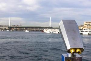 Tourist binoculars on the Galata Bridge in front of the Bosphorus Strait of Istanbul. photo