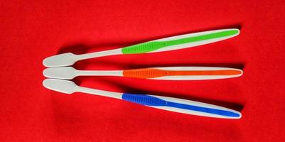 Three different colored toothbrushes, top view. photo