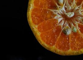 fresh ripe orange fruit on black background.  black background with orange properties photo