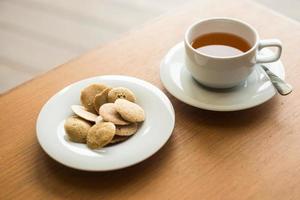 Afternoon Tea and Banana and Rice Berry Crispy on the wooden table photo