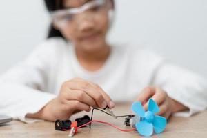 Asia students learn at home in coding robot cars and electronic board cables in STEM, STEAM, mathematics engineering science technology computer code in robotics for kids concept. photo