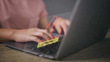 developer using computer laptop with triangle caution warning sign for notification error and maintenance concept. photo
