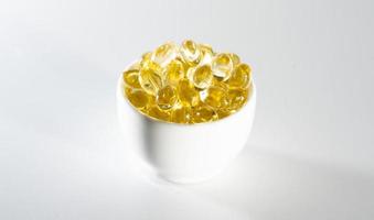 Food supplement oil filled fish oil, vitamin D, omega 3, omega 6, vitamin A, vitamin E, flaxseed oil. photo