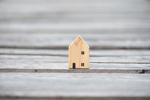 new home concept - young family with dream house scale model in hands photo