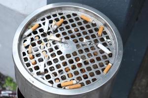 close up of burning cigarette on dark background photo