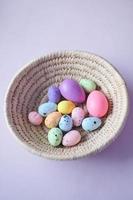 easter concept with multi color egg on pink background. photo