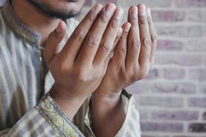 muslim man keep hand in praying gestures during ramadan, Close up photo