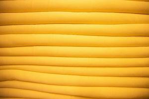 folded stacked Yellow sherpa fabric backdrop pattern can be used as a textured background photo