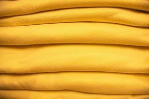 folded stacked Yellow sherpa fabric backdrop pattern can be used as a textured background photo